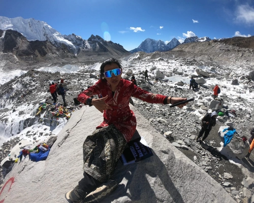 Beautiful Sherpa Lady At The Everest Base Camp With Panorama View In Background
